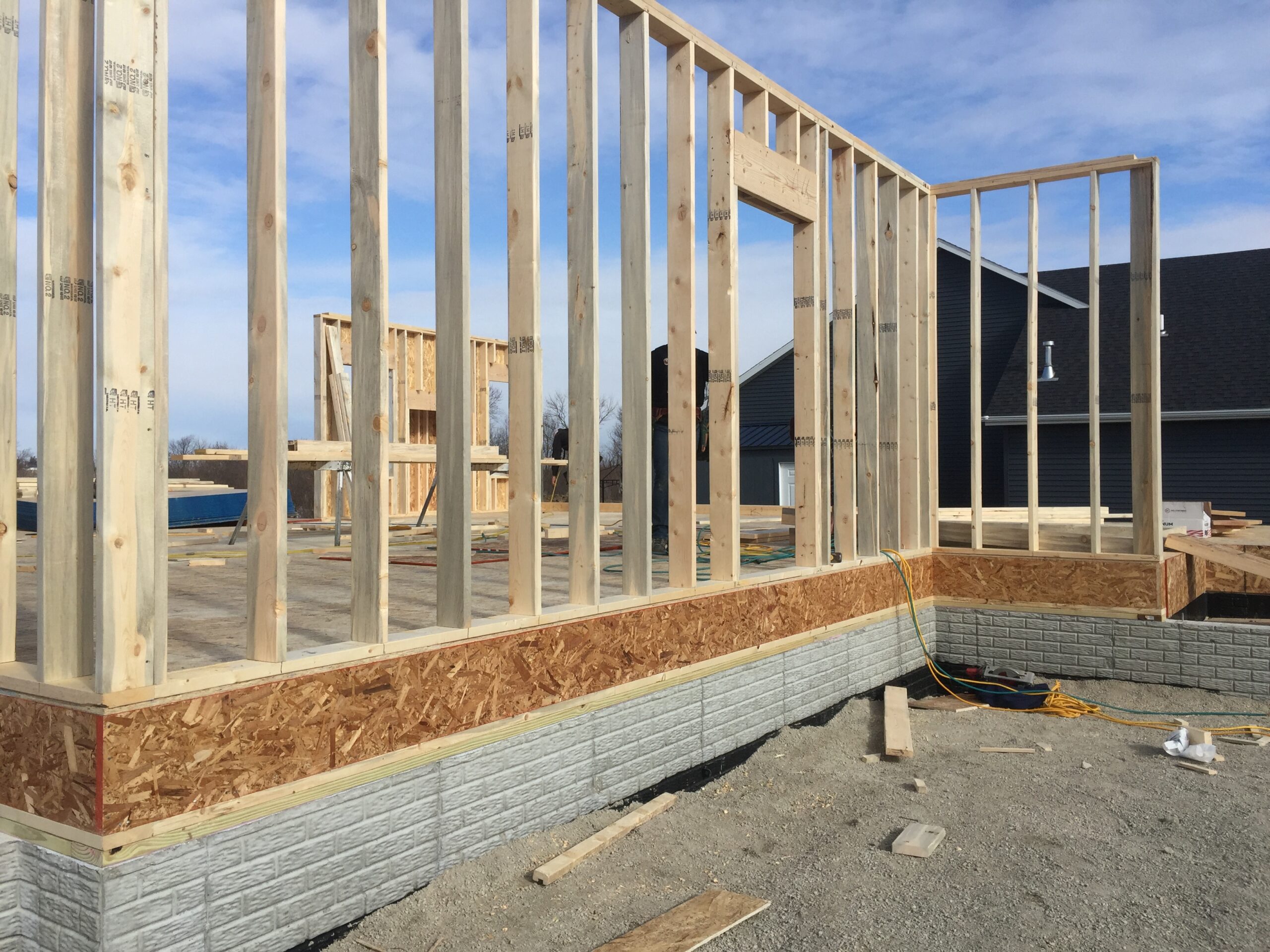 Exterior wall framing by Trego Custom Homes on a residential construction site