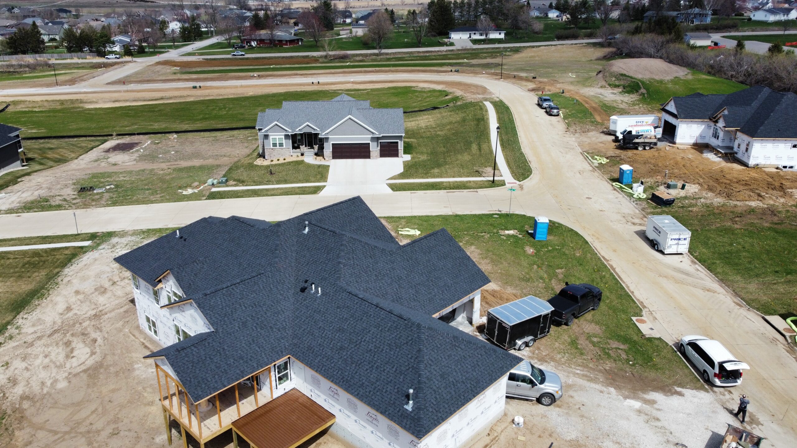 A new custom home with a freshly installed dark shingle r